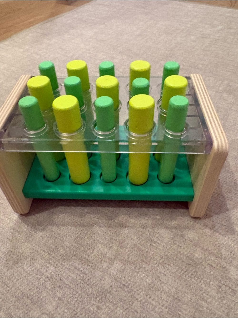Lovevery Wooden Peg Toy with Green and Yellow Pegs